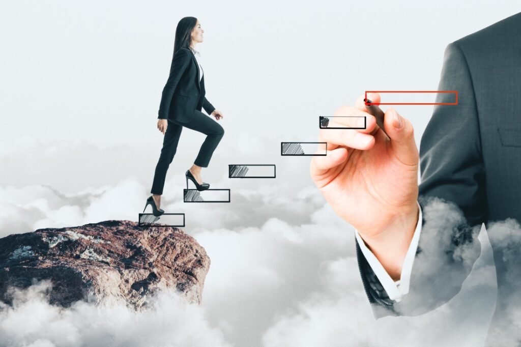 Businesswoman in suit climbing sketched steps over clouds towards a hand drawing the next step
